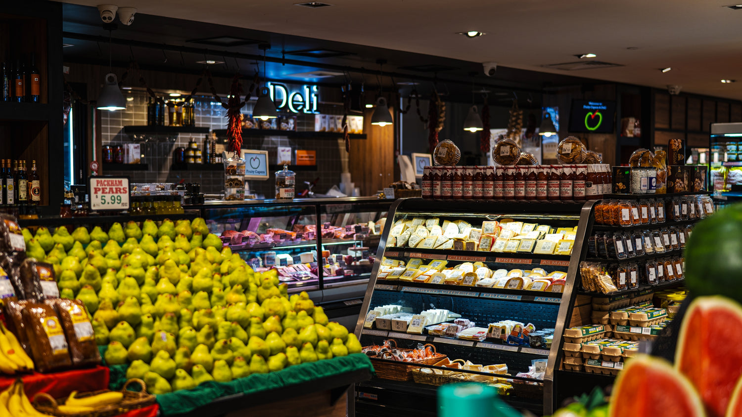 Deli case and fresh produce inside Fruity Capers & Deli